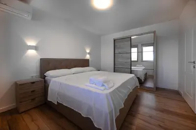 a bedroom with a bed with two towels on it at Gjerana SEAVIEW in Ulcinj