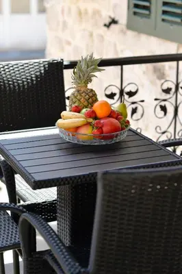 a plate of fruit sitting on a table at Antica Apartments in Kotor