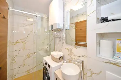 a bathroom with a toilet and a mirror at Antica Apartments in Kotor