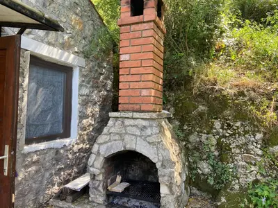 a brick oven in the side of a building at Stone & Sea house in Valdanos