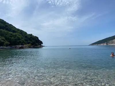 a person swimming in a body of water at Stone & Sea house in Valdanos