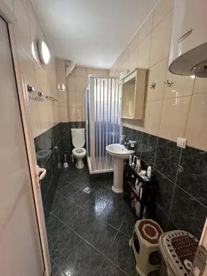 a bathroom with a sink and a toilet and a shower at Apartmani Mulic in Sutomore