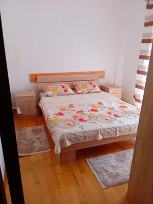 a bedroom with a bed and two pillows on it at Cosy 1 bedroom apartment BUDVA in Budva