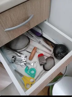 a drawer with various kitchen utensils in a cabinet at Cosy 1 bedroom apartment BUDVA in Budva