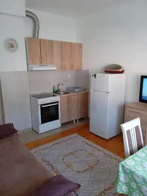 a kitchen with a white refrigerator and a stove at Cosy 1 bedroom apartment BUDVA in Budva