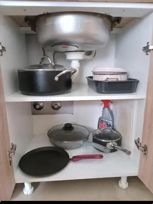 a kitchen shelf with pots and pans and a skillet at Cosy 1 bedroom apartment BUDVA in Budva