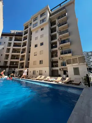 a swimming pool in front of a building at Apartment Montenegro Becici in Becici