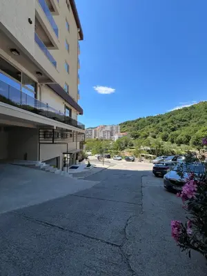 a parking lot next to a building with cars parked at Apartment Montenegro Becici in Becici