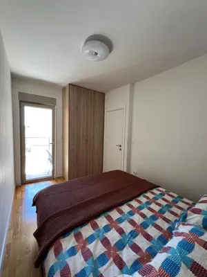 a bedroom with a bed with a quilt on it at Apartment Montenegro Becici in Becici