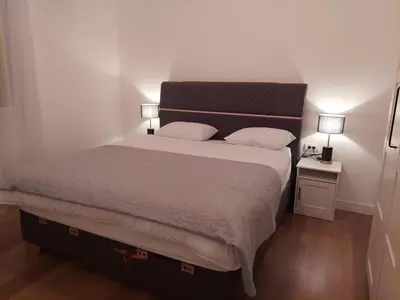 a bedroom with a large bed with two lamps on tables at Giardino in Muo
