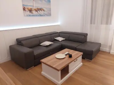 a living room with a couch and a coffee table at Giardino in Muo
