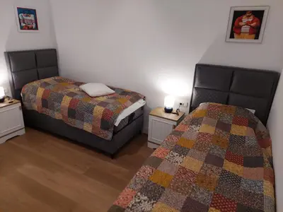 a bedroom with two beds and two night stands at Giardino in Muo