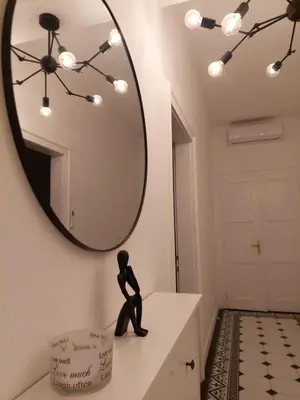 a bathroom with a mirror and a statue on a dresser at Giardino in Muo