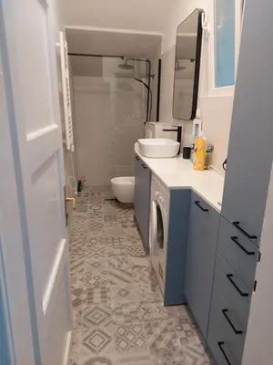 a bathroom with a sink and a washing machine at Giardino in Muo