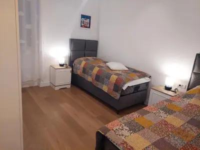 a bedroom with two beds and two night stands at Giardino in Muo
