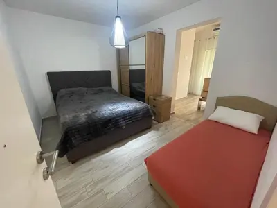 a bedroom with a bed and a mirror at Belaapartman in Kravlja