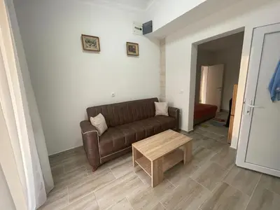 a living room with a couch and a coffee table at Belaapartman in Kravlja