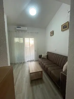 a living room with a couch and a coffee table at Belaapartman in Kravlja