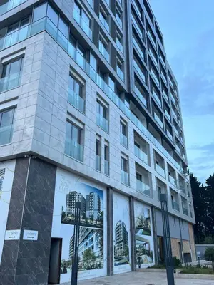 a tall building with posters on the side of it at Sal y Sol in Bar