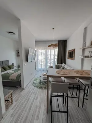 a living room with a dining table and a bedroom at Sal y Sol in Bar