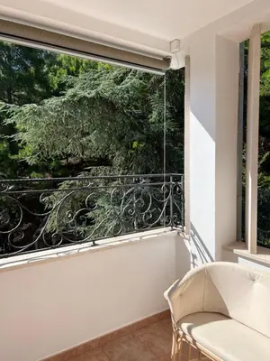 a room with a large window with a couch and a chair at Montenegro Seaside Lux Apartment in Petrovac na Moru