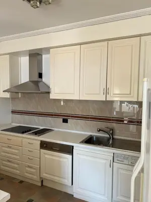 a kitchen with white cabinets and a sink at Montenegro Seaside Lux Apartment in Petrovac na Moru