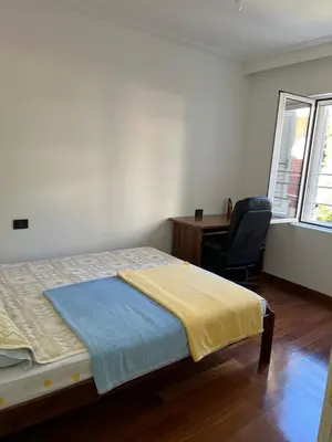 a bedroom with a bed and a desk and a chair at Montenegro Seaside Lux Apartment in Petrovac na Moru