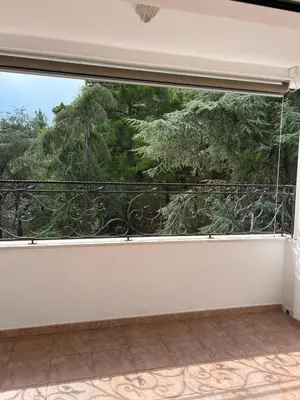 an empty balcony with a large window with trees at Montenegro Seaside Lux Apartment in Petrovac na Moru