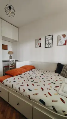 a bedroom with a large bed with a colorful comforter at Cozy & Bright Garden Flat in Podgorica