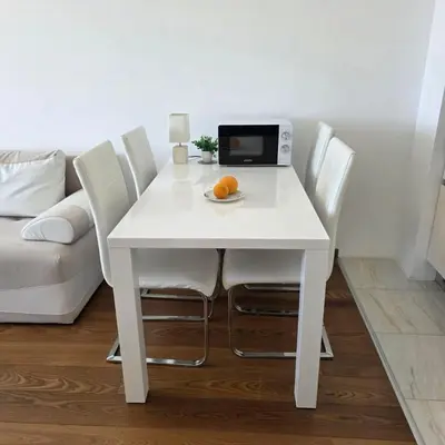 a white table with chairs and a laptop on it at Summer vacation near Sveti Stefan in Podličak