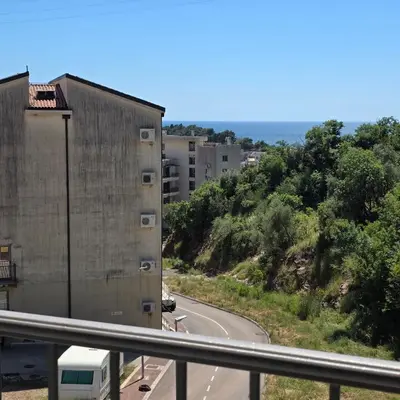 a road with a building on the side of the road at Summer vacation near Sveti Stefan in Podličak