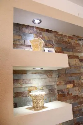 a brick wall with a vase on a shelf at Lilian Apartments in Budva