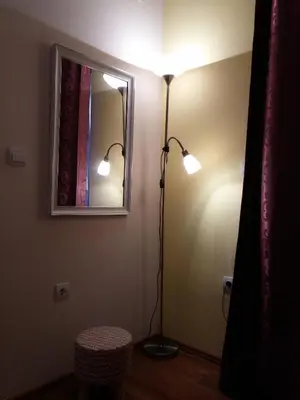 a room with a lamp and a mirror on the wall at Lilian Apartments in Budva