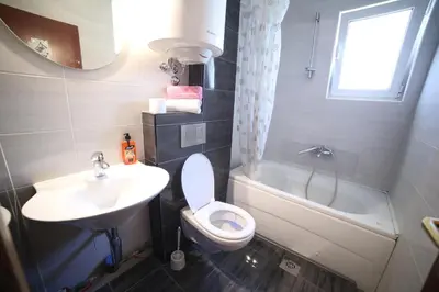 a bathroom with a toilet and a sink and a tub at Lilian Apartments in Budva