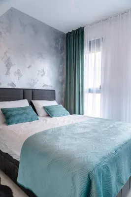 a bedroom with a large bed and a window at Apartment BAR M3B in Bar