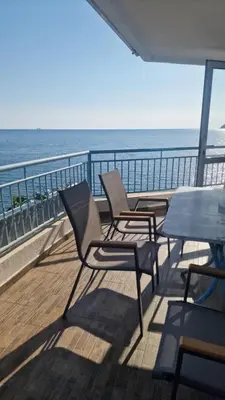 two chairs and a table on a balcony overlooking the ocean at Apartmani Orange Dreams in Sutomore
