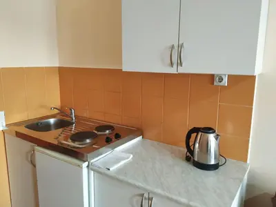 a kitchen with a sink and a tea kettle on a counter at Apartmani Orange Dreams in Sutomore