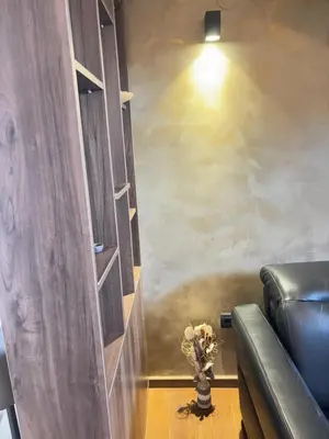 a living room with a couch and a vase of flowers at Loft Suite in Budva