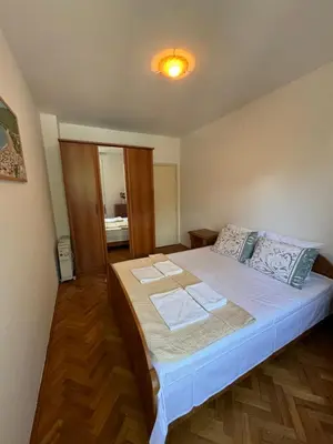 a bedroom with a bed with two towels on it at Apartman OLIVA3 in Petrovac na Moru