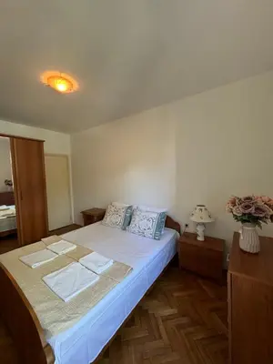 a bedroom with a large bed in a room at Apartman OLIVA3 in Petrovac na Moru
