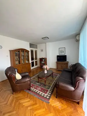 a living room with two leather chairs and a coffee table at Apartman OLIVA3 in Petrovac na Moru