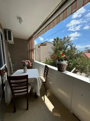 a patio with a table and chairs on a balcony at Apartman OLIVA3 in Petrovac na Moru