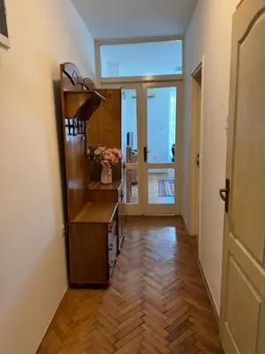 a hallway with a room with a wooden floor at Apartman OLIVA3 in Petrovac na Moru
