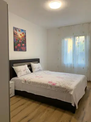 a bedroom with a bed and a painting on the wall at Utjeha house Ana in Utjeha