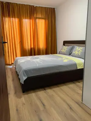 a bed in a bedroom with an orange curtain at Utjeha house Ana in Utjeha