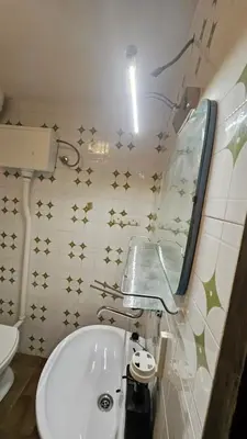 a bathroom with a toilet and a tub and a mirror at Utjeha house Ana in Utjeha