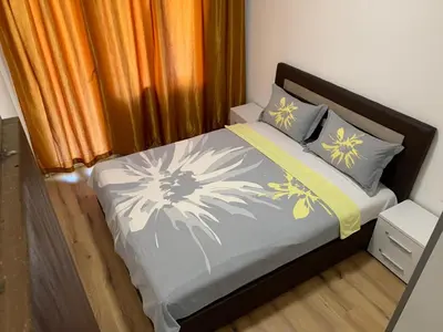 a bedroom with a bed with yellow and gray pillows at Utjeha house Ana in Utjeha