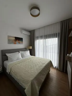 a bedroom with a bed and a large window at Namai Apartments in Ulcinj
