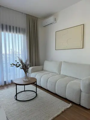 a living room with a white couch and a table at Namai Apartments in Ulcinj