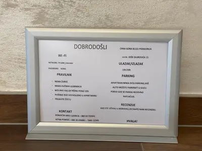 a picture of a framed menu in a white frame at Apartman Sahat kula in Podgorica